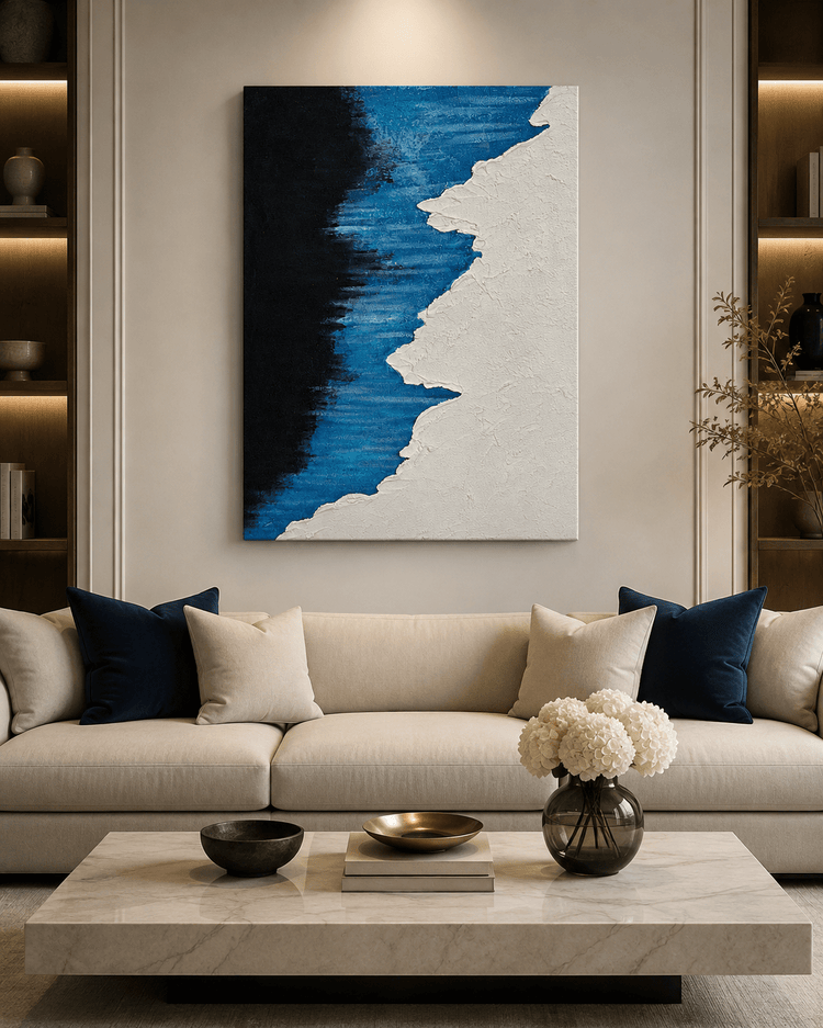 Beige sofa with blue cushions and marble coffee table, Wallsmark INC abstract wall art in living room setting.