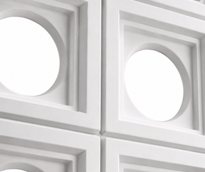 Breeze Block PU Stone Panel features a white geometric wall design with a grid of square panels, each showcasing a central circular cutout. This decorative wall panel creates a modern, repetitive pattern where shadows and highlights accentuate its three-dimensional form—an ideal choice for distinctive interior wall cladding.