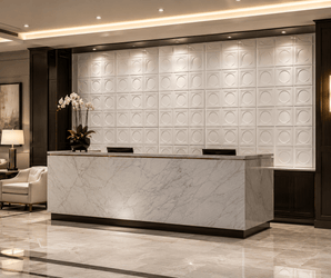 Modern hotel reception area with a marble front desk, an orchid plant, a striking feature wall of Breeze Block PU Stone Panels, warm lighting, and elegant seating in the background.