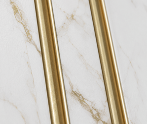 Gold metal rods on white marble with brown veining, suitable for accent wall panel or cladding applications.