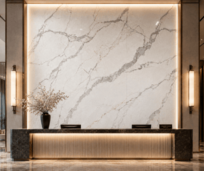 Decorative wall panels in a modern hotel lobby with a sleek reception desk and floral vase on the left side.
