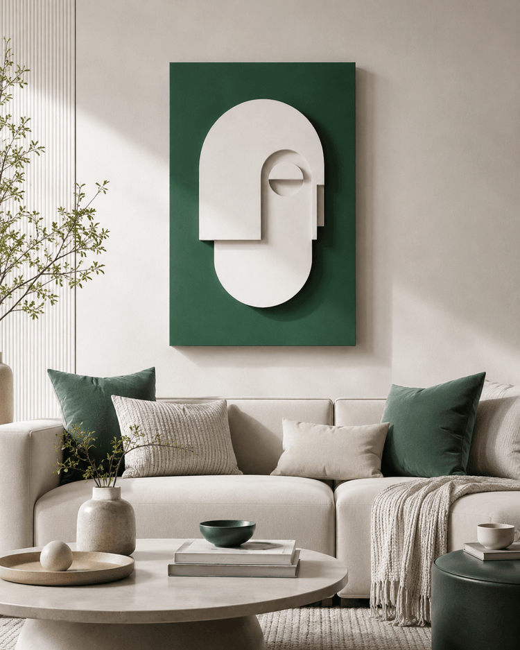 Emerald green wall art above neutral sofas with green pillows and a round table in a modern living room setting.