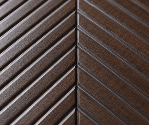 Close-up of the Espresso Chevron PS Wall Panel, showcasing its dark brown finish and distinctive chevron pattern formed by diagonal grooves that converge along a central line—a standout example of decorative wall panel design, perfect for use as a feature wall.
