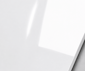 High-Gloss White Wall Panel with reflective finish displayed on a smooth grey surface.