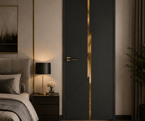 Black and gold interior door in a modern bedroom with bed, nightstand, lamp, potted plant, and warm lighting.