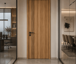 Modern oak interior door with black vertical inlays in a hallway, glass-walled offices on each side.