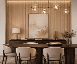 Beige dining chairs and dark wood table with decorative accent wall panels displaying abstract artwork and pendant lights.
