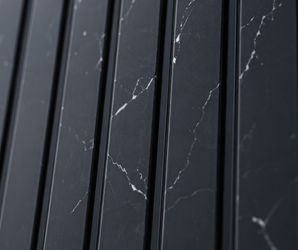 Close-up of Nero Marquina Fluted PS Wall Panel, featuring vertical black marble panels with white veining that form a sleek and modern geometric pattern.