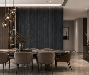Modern dining room with a marble table, six cushioned chairs, pendant lights, and the Nero Marquina Fluted PS Wall Panel serving as a striking dark textured accent wall. Minimalist decor and vases of greenery complement the neutral color palette, while soft lighting adds to the sophisticated atmosphere.