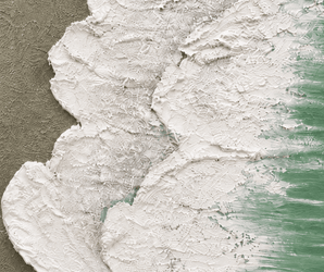 Coastal wall art with textured white paint on a rough greenish surface, resembling ocean waves.
