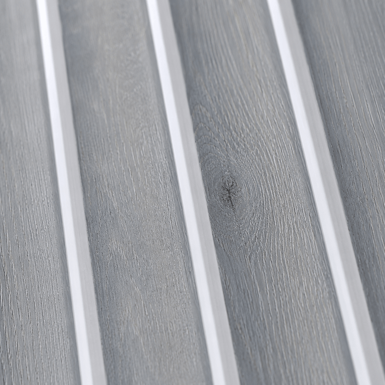 Close-up of the Silver Ash Fluted PS Wall Panel, featuring light gray wood tones with distinct grain patterns and sleek vertical white dividers—an ideal choice for an elegant interior or decorative wall panel in any modern setting.