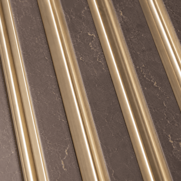 The Taupe Gold Fluted PS Wall Panel features diagonal gold metallic strips set against a brown, marble-textured surface, creating a striking modern geometric pattern with alternating materials—an ideal choice for luxury wall panels that elevate any interior.