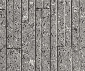 Close-up of the Terraz Soft Stone wall panel featuring textured gray rectangular blocks arranged in a staggered, geometric pattern. The surface displays small pits and speckles, creating a rough and uneven appearance.