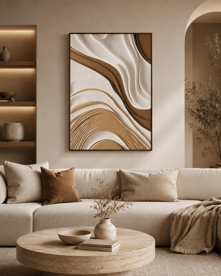 Beige living room with sculptural wall art, neutral pillows, round coffee table, and shelving with decorative vases.